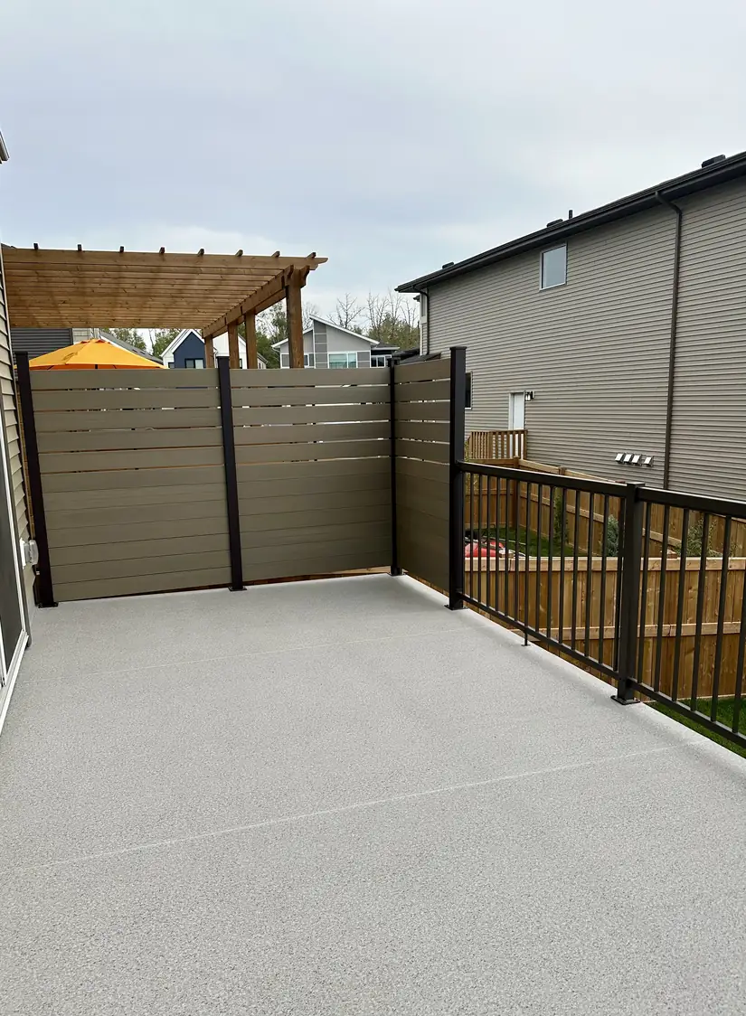 Deck with privacy wall and black aluminum railing, Edmonton — TrueBlue Builders Ltd